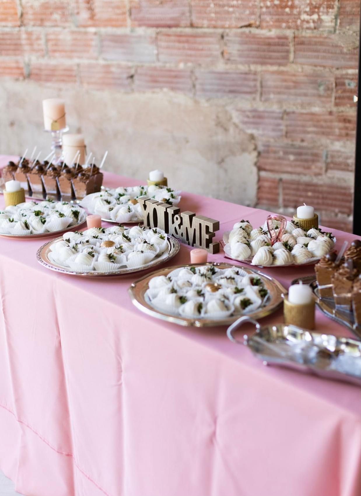 Dessert table against exposed brick